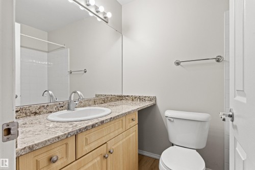 Bathroom vanity with a light-toned countertop, under-mount sink, and chrome faucet - #404 11103 84 Av Nw, Edmonton, AB - Indoor Photo Showing Bathroom