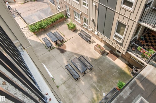 Paved outdoor courtyard featuring multiple picnic tables and benches - #404 11103 84 Av Nw, Edmonton, AB - Indoor Photo Showing Other Room
