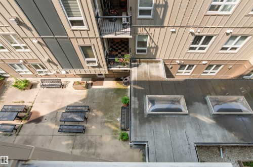 Concrete patio area featuring multiple benches and tables - #404 11103 84 Av Nw, Edmonton, AB - Indoor Photo Showing Other Room