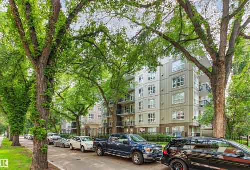 Multi-story building with multiple balconies, white-framed windows, and a landscaped green space - #404 11103 84 Av Nw, Edmonton, AB - Outdoor