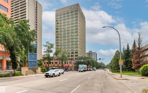 Urban streetscape with multi-story buildings, mature trees, and paved roadways - #404 11103 84 Av Nw, Edmonton, AB - Outdoor With Facade