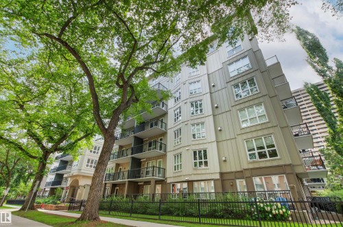 Multi-story building featuring a contemporary facade, individual balconies, and a black metal fence - #404 11103 84 Av Nw, Edmonton, AB - Outdoor With Balcony With Facade