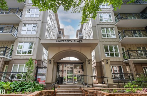 Multi-story building with a central arched entryway and prominent exterior signage - #404 11103 84 Av Nw, Edmonton, AB - Outdoor With Balcony With Facade