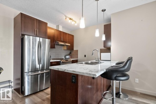 #307 1144 Adamson Dr Sw Sw, Edmonton, AB - Indoor Photo Showing Kitchen With Stainless Steel Kitchen With Double Sink