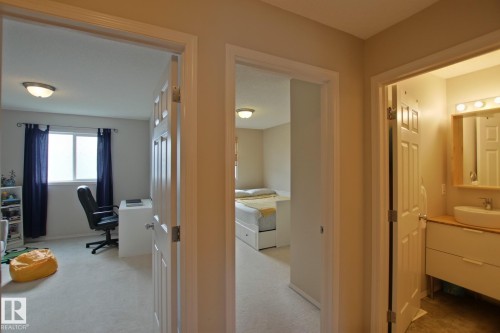 Hallway featuring neutral-toned walls and carpeted flooring - #42 4350 23 St Nw, Edmonton, AB - Indoor