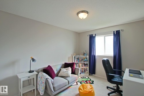 Recessed lighting, painted walls, wall-to-wall carpeting, and a window with curtain rods - #42 4350 23 St Nw, Edmonton, AB - Indoor