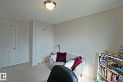 Bright secondary bedroom featuring neutral carpeting, dual closet storage with six-panel doors, and recessed ceiling lighting - #42 4350 23 St Nw, Edmonton, AB - Indoor