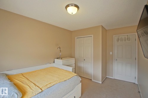 Recessed lighting, neutral wall paint, white trim, and light-colored carpeting - #42 4350 23 St Nw, Edmonton, AB - Indoor Photo Showing Bedroom