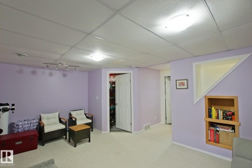 Recessed built-in shelving, track lighting, and a drop ceiling - #42 4350 23 St Nw, Edmonton, AB - Indoor