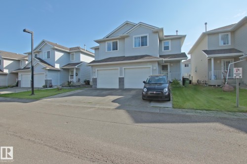 Two-story residential architecture with light-colored siding - #42 4350 23 St Nw, Edmonton, AB - Outdoor With Facade