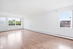Wood-finish flooring, white walls, white trim, and multiple windows - 