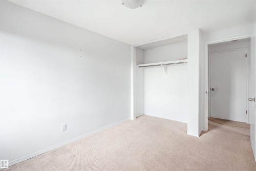 Recessed closet with a single shelf and hanging rod - 7825 159 Street Nw, Edmonton, AB - Indoor Photo Showing Other Room