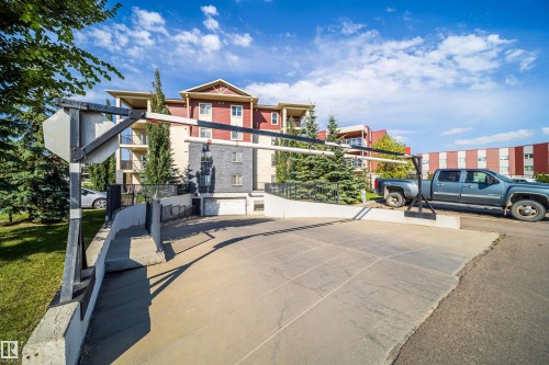 Underground parking access ramp with barrier arm system - #315 5816 Mullen Pl Nw, Edmonton, AB - Outdoor