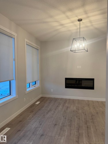 5316 Godson Point(E) Nw, Edmonton, AB - Indoor Photo Showing Other Room With Fireplace