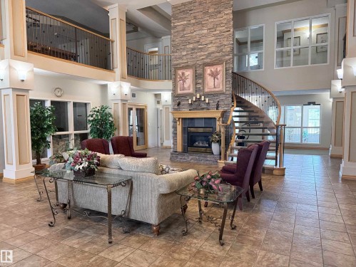 #131 11260 153 Av Nw, Edmonton, AB - Indoor Photo Showing Living Room With Fireplace