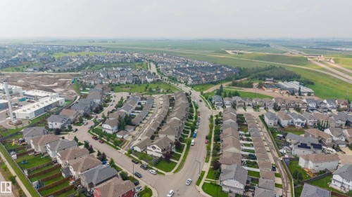 Aerial perspective showcasing a residential development with multiple detached homes - 124 Cy Becker Boulevard Nw, Edmonton, AB - Outdoor With View