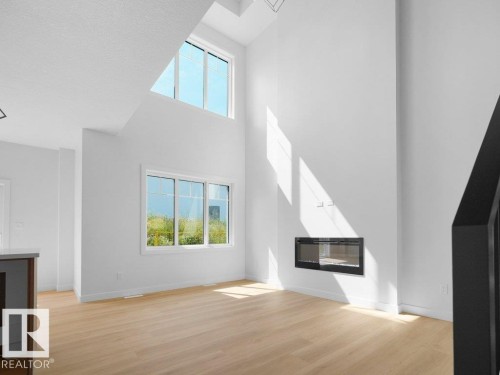 1423 Osprey Crest Nw, Edmonton, AB - Indoor Photo Showing Other Room With Fireplace