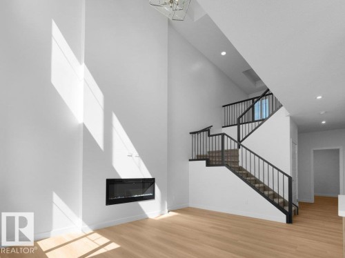 1423 Osprey Crest Nw, Edmonton, AB - Indoor Photo Showing Other Room With Fireplace