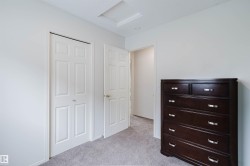 White paneled interior doors, light gray carpet flooring, and white baseboards - 
