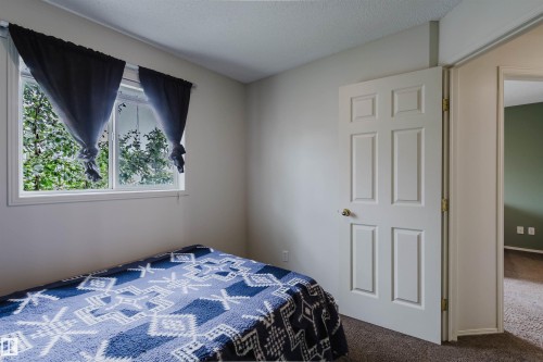 Light-colored walls complement the warm-toned carpeting - 1694 Tompkins Wynd Nw, Edmonton, AB - Indoor Photo Showing Bedroom