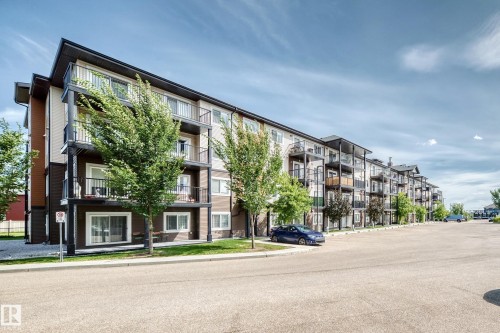 Multi-story residential building with private balconies and ground-floor patios - #322 148 Ebbers Bv Nw, Edmonton, AB - Outdoor With Balcony With Facade