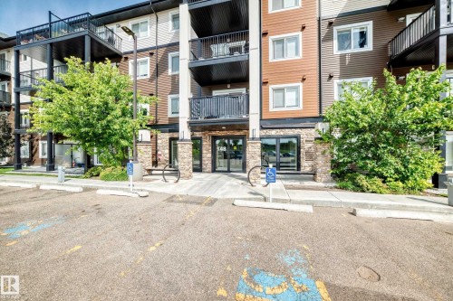 Multi-story building with textured siding and stone accents - #322 148 Ebbers Bv Nw, Edmonton, AB - Outdoor With Balcony