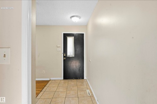 Tile flooring entryway with a flush mount ceiling light - 13604 90A Street Nw, Edmonton, AB - Indoor Photo Showing Other Room