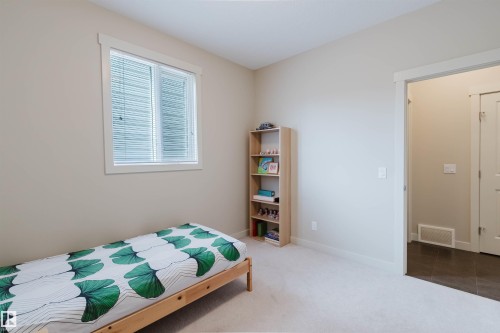 Light-colored carpeting, a white-trimmed window, and neutral wall paint - 3843 Agar Green Sw, Edmonton, AB - Indoor Photo Showing Bedroom