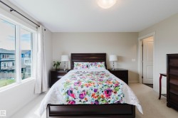 Neutral wall color, wall-to-wall carpeting, white trim, recessed ceiling light fixture, and a window with white casing - 