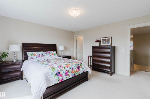 Neutral tone wall paint, flush mount ceiling light fixture, and carpet flooring - 3843 Agar Green Sw, Edmonton, AB - Indoor Photo Showing Bedroom