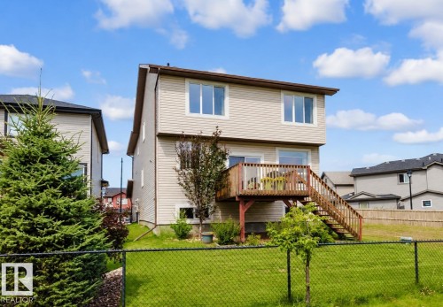 Rear exterior with light-colored siding and a multi-level wooden deck - 3843 Agar Green Sw, Edmonton, AB - Outdoor