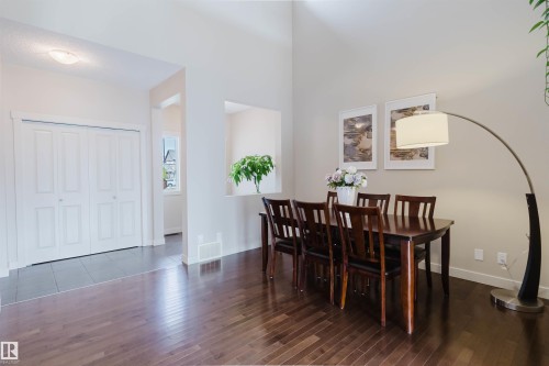 High ceilings with recessed lighting, wood-finish flooring, and white bi-fold closet doors - 3843 Agar Green Sw, Edmonton, AB - Indoor Photo Showing Dining Room