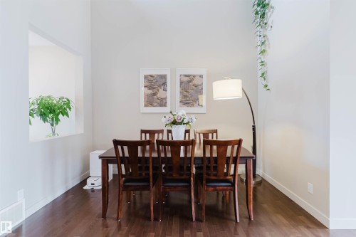 Hardwood-style flooring, light-toned walls, and a built-in wall niche - 3843 Agar Green Sw, Edmonton, AB - Indoor Photo Showing Dining Room