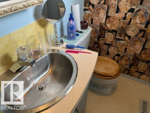 Bathroom vanity featuring an oval drop-in sink with a chrome faucet - 13508 64 Street Nw, Edmonton, AB - Indoor Photo Showing Laundry Room