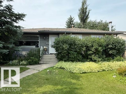 Single-story residence featuring grey siding and a white entry door - 13508 64 Street Nw, Edmonton, AB - Outdoor