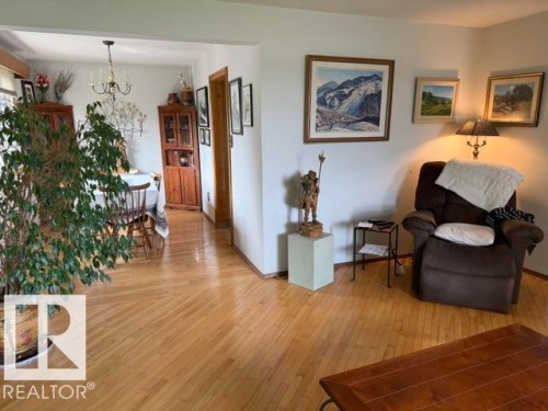 Hardwood flooring throughout featuring a diagonal pattern in the foreground - 13508 64 Street Nw, Edmonton, AB - Indoor