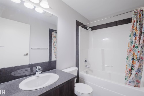 Integrated vanity with an undermount sink, a chrome faucet, and a large wall-mounted mirror - #2207 10226 104 St Nw, Edmonton, AB - Indoor Photo Showing Bathroom