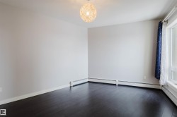 Dark wood-finish flooring with white walls and baseboards - 