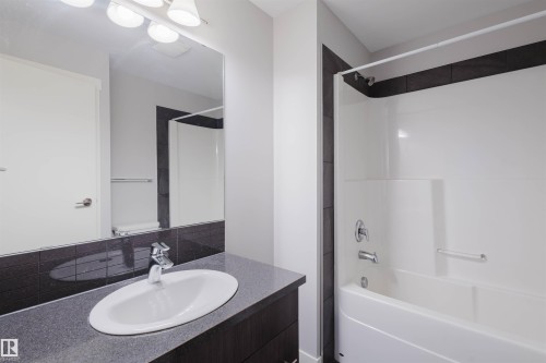 Vanity with integrated oval sink, chrome faucet, and spacious countertop - #2207 10226 104 St Nw, Edmonton, AB - Indoor Photo Showing Bathroom