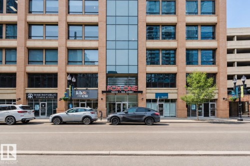 Multi-story commercial building featuring brick and glass facade - #2207 10226 104 St Nw, Edmonton, AB - Outdoor With Balcony With Facade