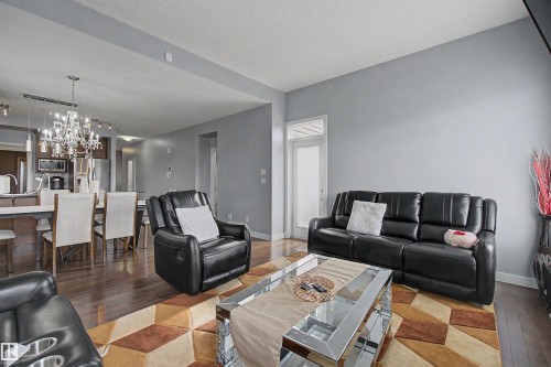 Hardwood-finish flooring throughout, with a recessed beam ceiling feature - 1602 Chapman Way Sw, Edmonton, AB - Indoor Photo Showing Living Room