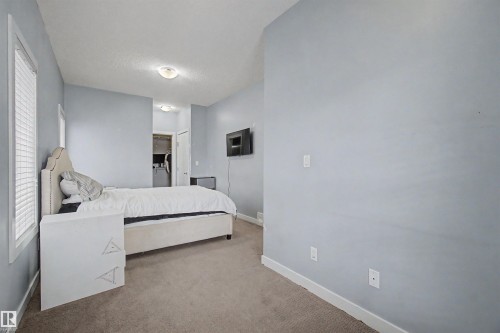 Carpeted flooring, light blue wall paint, recessed ceiling lighting, and a window with blinds - 1602 Chapman Way Sw, Edmonton, AB - Indoor Photo Showing Bedroom