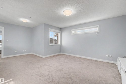 Neutral-toned carpeting throughout - 1602 Chapman Way Sw, Edmonton, AB - Indoor Photo Showing Other Room