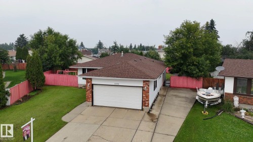 Single-story residence featuring a two-car garage, brick accents, and a shingled roof - 16524 116 Street Nw, Edmonton, AB - Outdoor