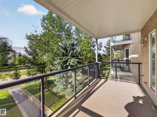 Covered balcony featuring glass railing - #314 237 Youville Dr E Nw, Edmonton, AB - Outdoor With Balcony With Exterior