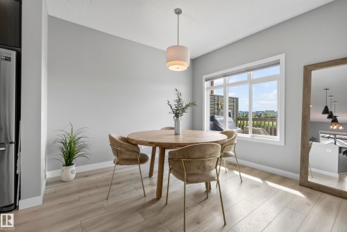 Recessed lighting, wood-finish flooring, white trim, and a built-in stainless steel refrigerator - 45 Joyal Way, St. Albert, AB - Indoor Photo Showing Dining Room