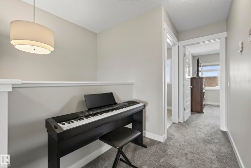 Recessed wall niche with a contemporary pendant light fixture, light gray wall paint, and white trim - 45 Joyal Way, St. Albert, AB - Indoor Photo Showing Office
