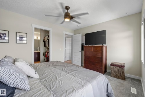 Bedroom with carpet flooring, a ceiling fan, and a built-in closet system - 45 Joyal Way, St. Albert, AB - Indoor Photo Showing Bedroom