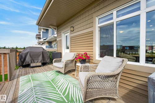 Spacious outdoor deck with wood-finish flooring, wood railing, and shingle-style siding - 45 Joyal Way, St. Albert, AB - Outdoor With Deck Patio Veranda With Exterior