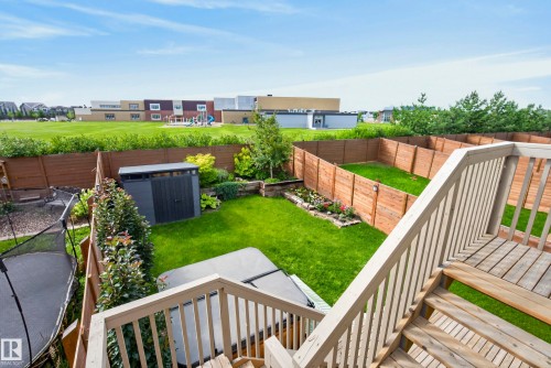 Expansive backyard featuring a multi-level wood deck, a hot tub, and a storage shed - 45 Joyal Way, St. Albert, AB - Outdoor With Deck Patio Veranda